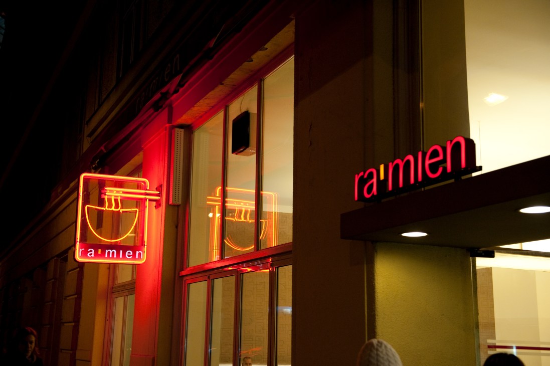 Ra'mien Japanese restaurant storefront at night with red and yellow neon signage.