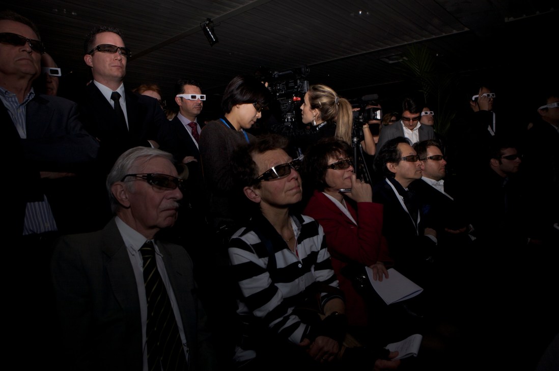 Visitors wearing 3D glasses watching a presentation at Hublot's BaselWorld stand.