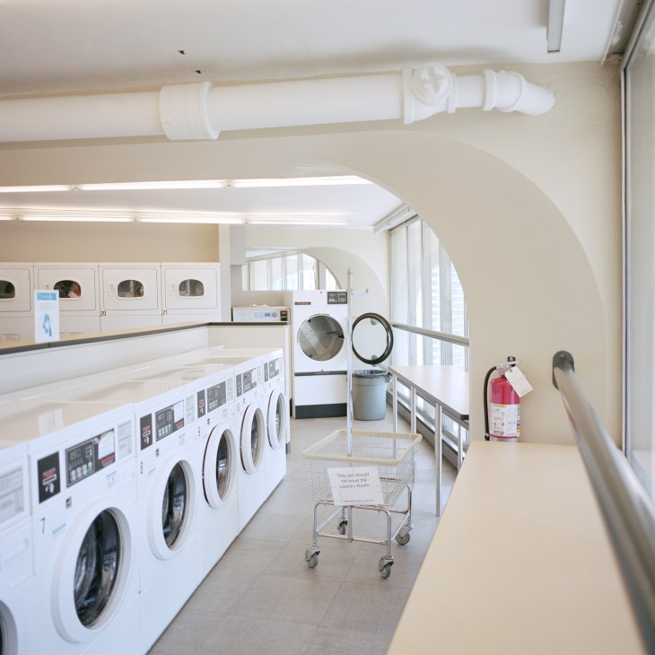Marina City's communal laundromat with white washing machines and dryers along curved walls.
