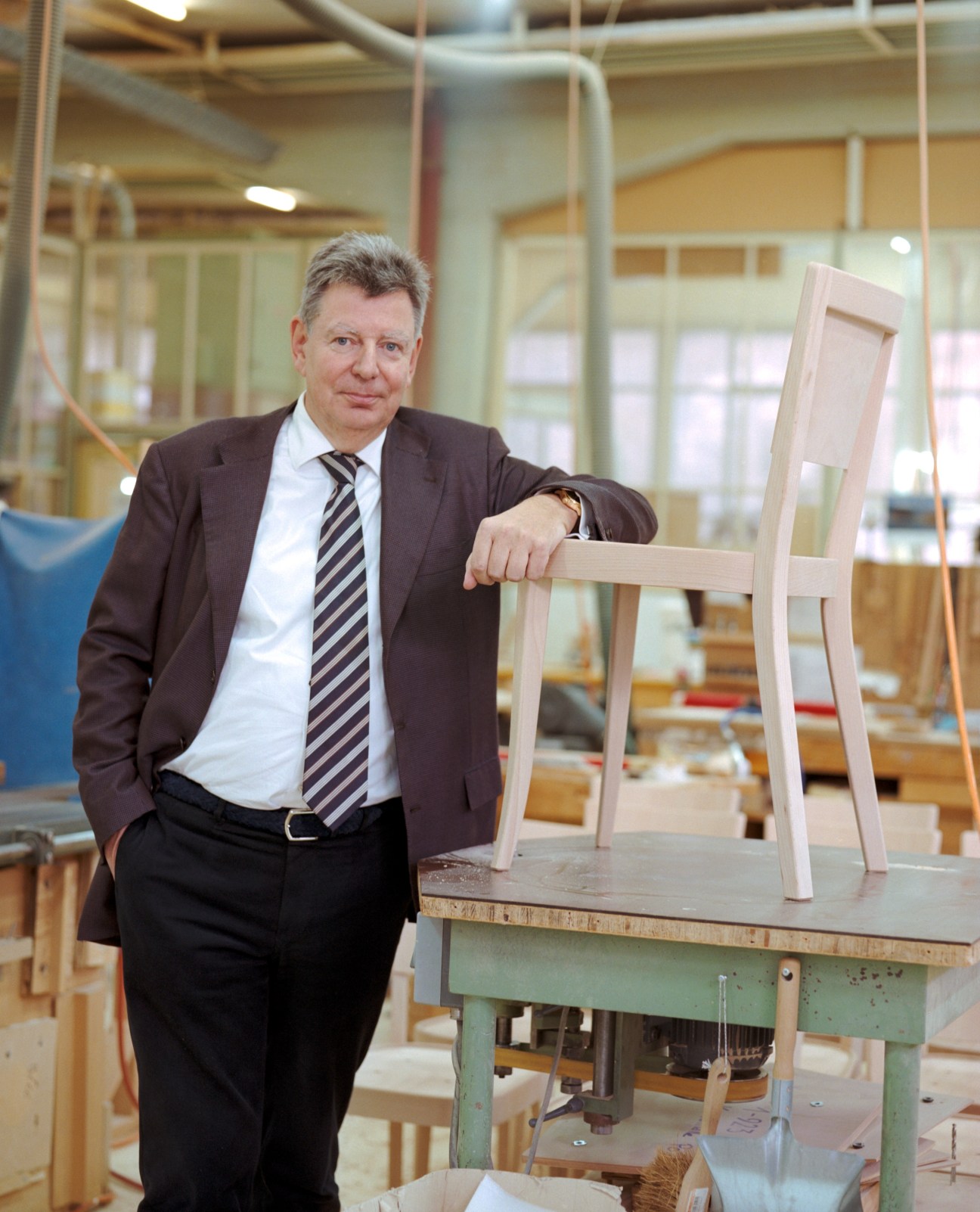 Michael Sarp, CEO of Nordeck-Gruppe, poses with an unfinished wooden chair in the Horgenglarus factory.