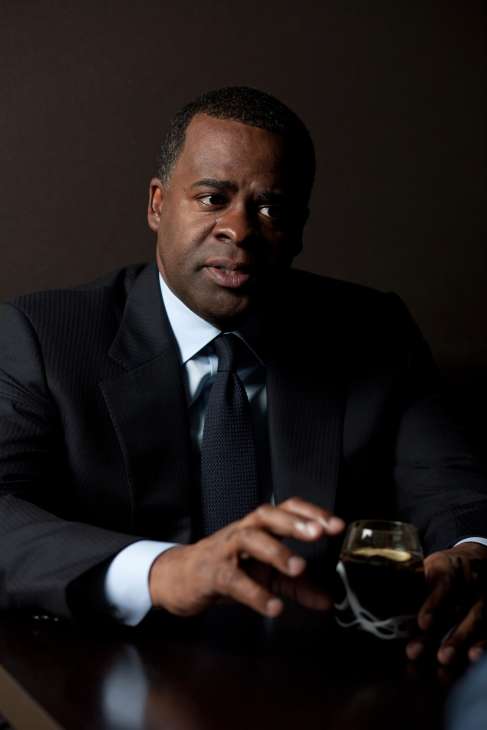 Portrait of Kasim Reed, Mayor of Atlanta, in a dark suit and tie against a dark background.