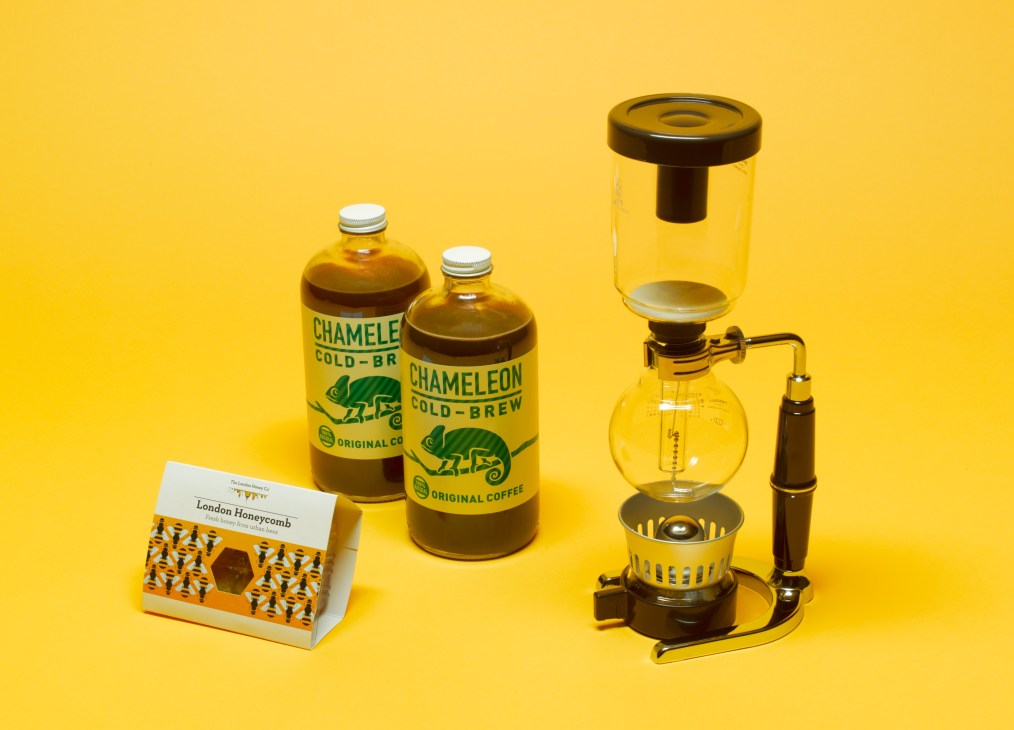 Chameleon Cold-Brew coffee bottles, London Honeycomb box, and Hario coffee syphon brewer on yellow background.