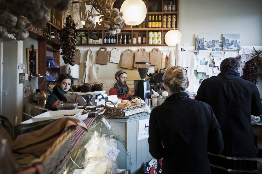 Staff serve customers at a corner grocery shop in Dublin's Smithfield neighbourhood.
