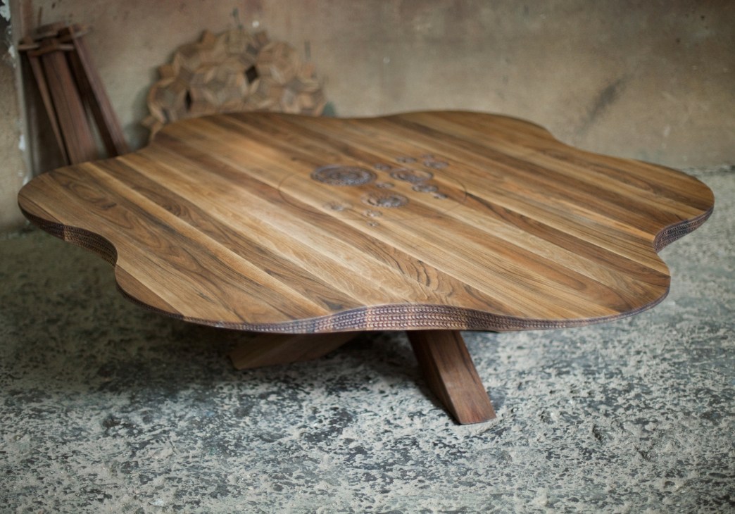 Daisy table by Salih Teskeredzic, a wooden table with curved cloud-like edges and decorative metal handles.