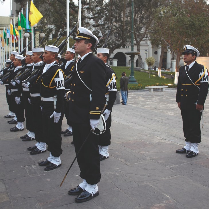 Peruvian military honour guard in dress uniforms standing outside the Legislative Palace in Lima.