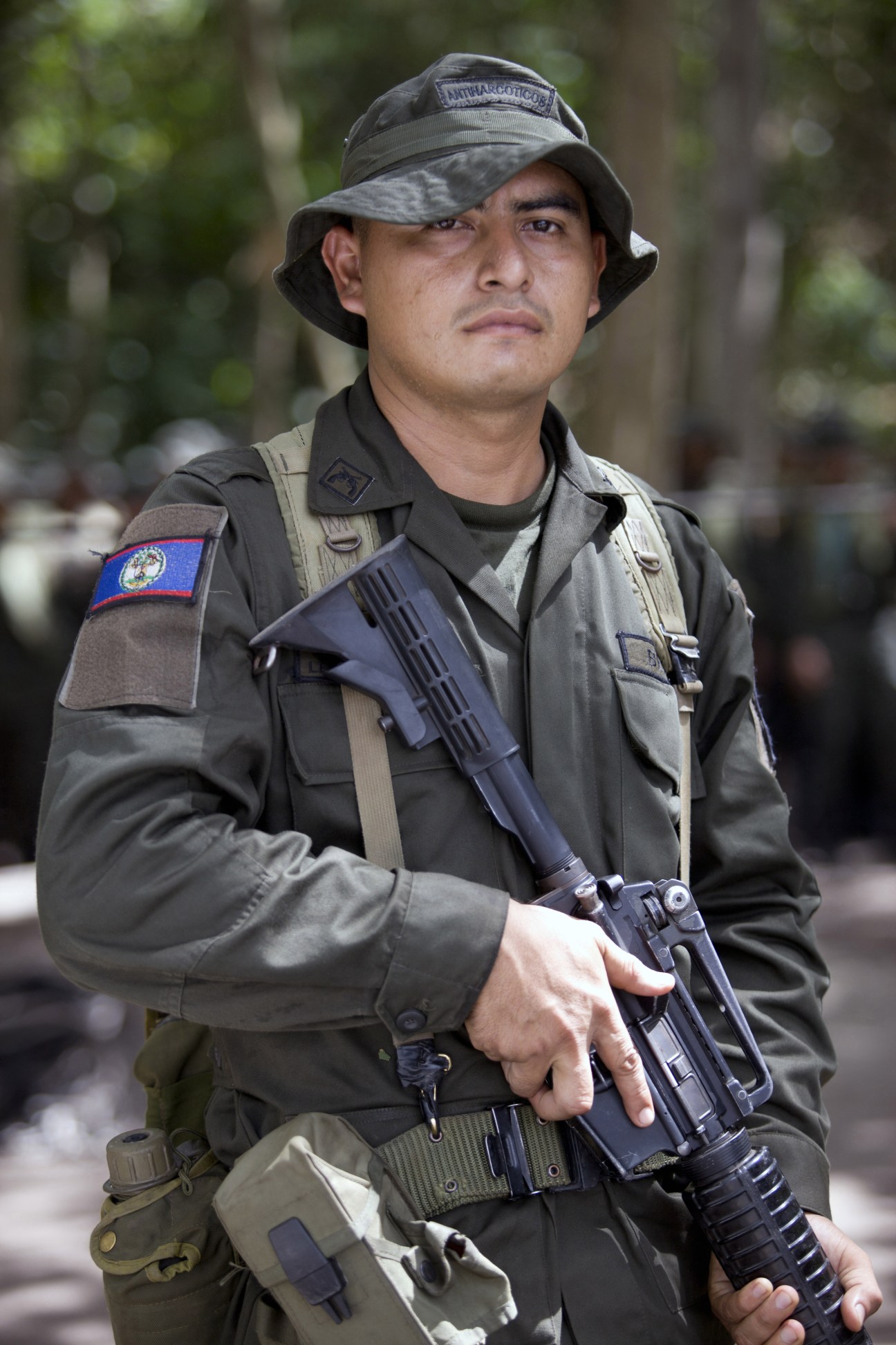 Belize police officer in tactical gear holding rifle at Jungla training course