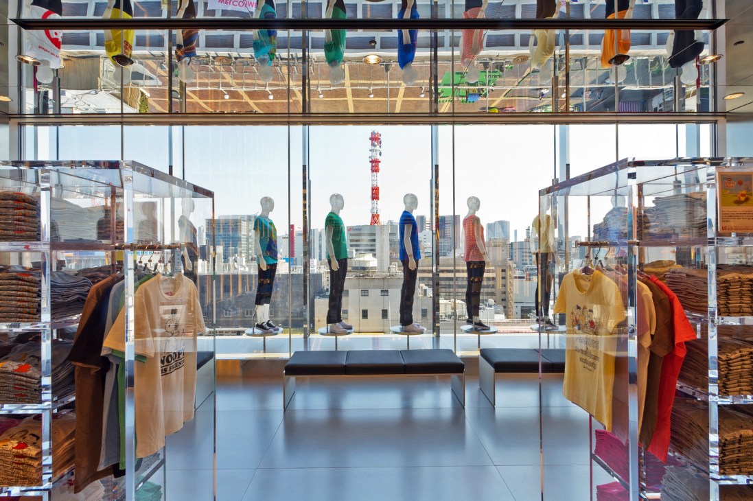 Uniqlo's 11th floor display with mannequins wearing colorful clothing and Tokyo cityscape visible through floor-to-ceiling windows.