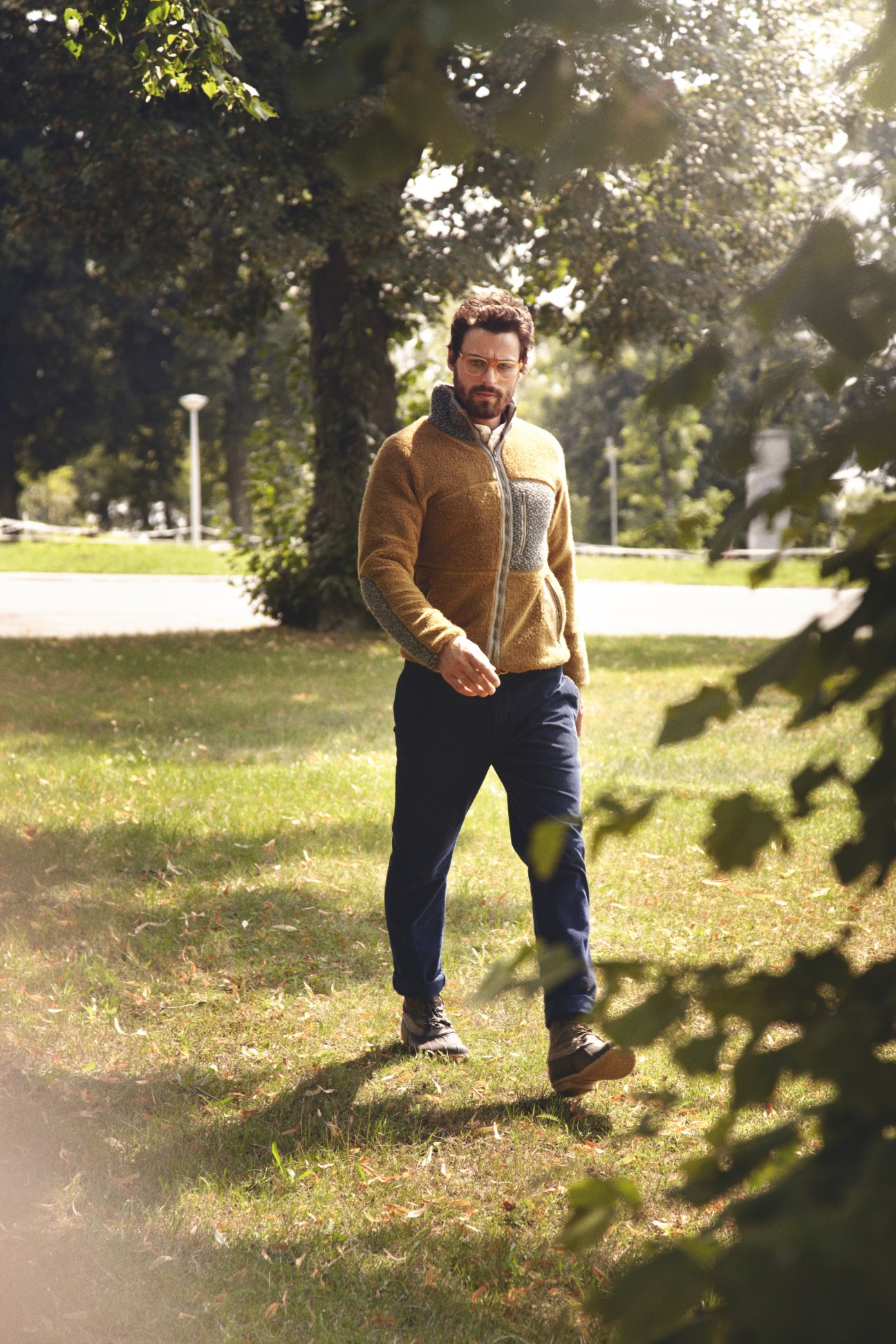 Man wearing FilMelange top, Needles shirt, and Boglioli trousers standing in tree-lined park at Wannsee.