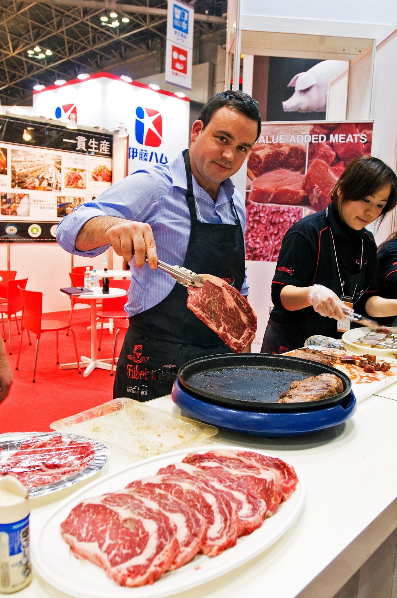 A meat company vendor cooks and serves fried steaks at the Japan Supermarket Trade Show.