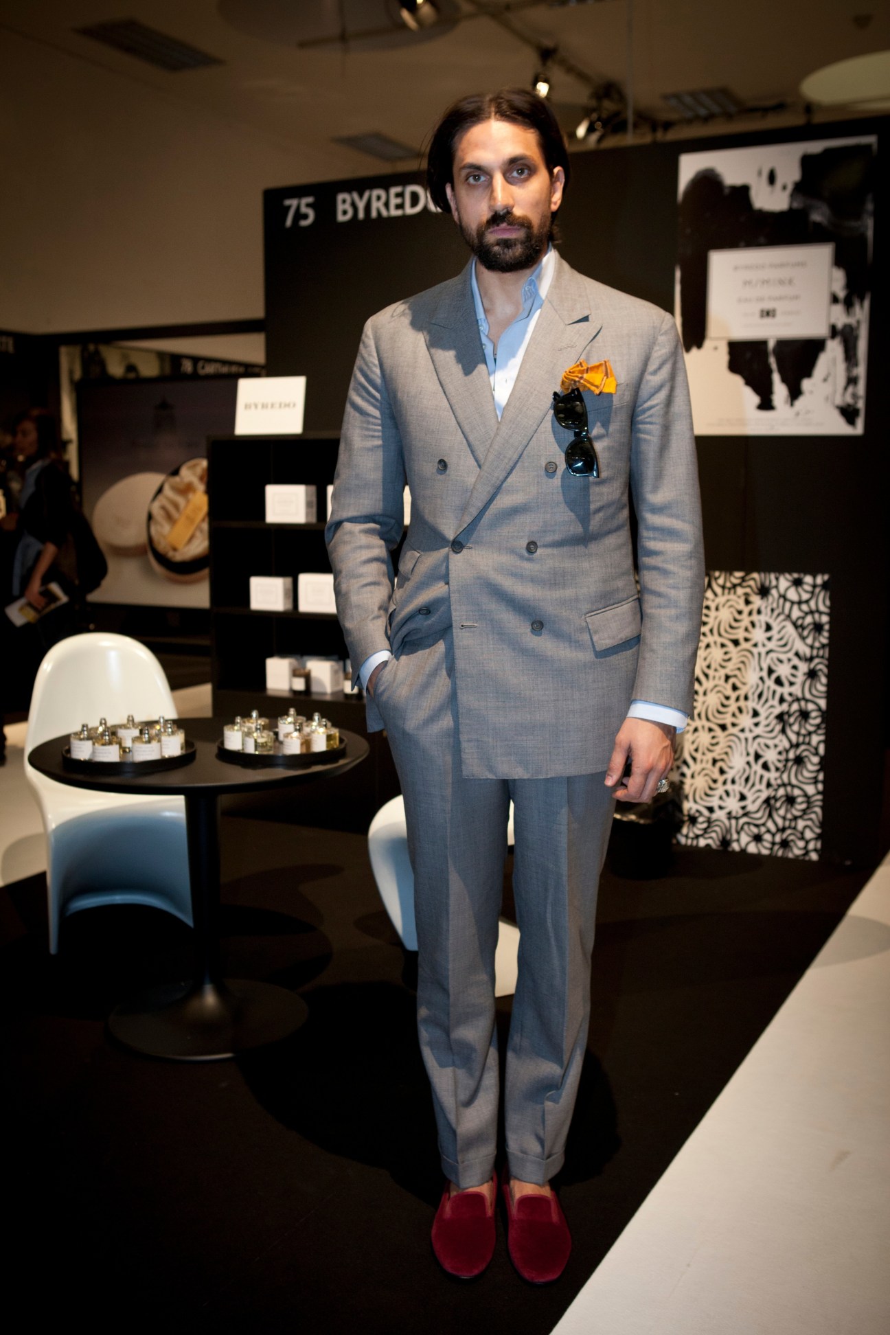 Ben Gorham, Byredo founder, stands at the Esxence trade fair in a grey double-breasted suit.