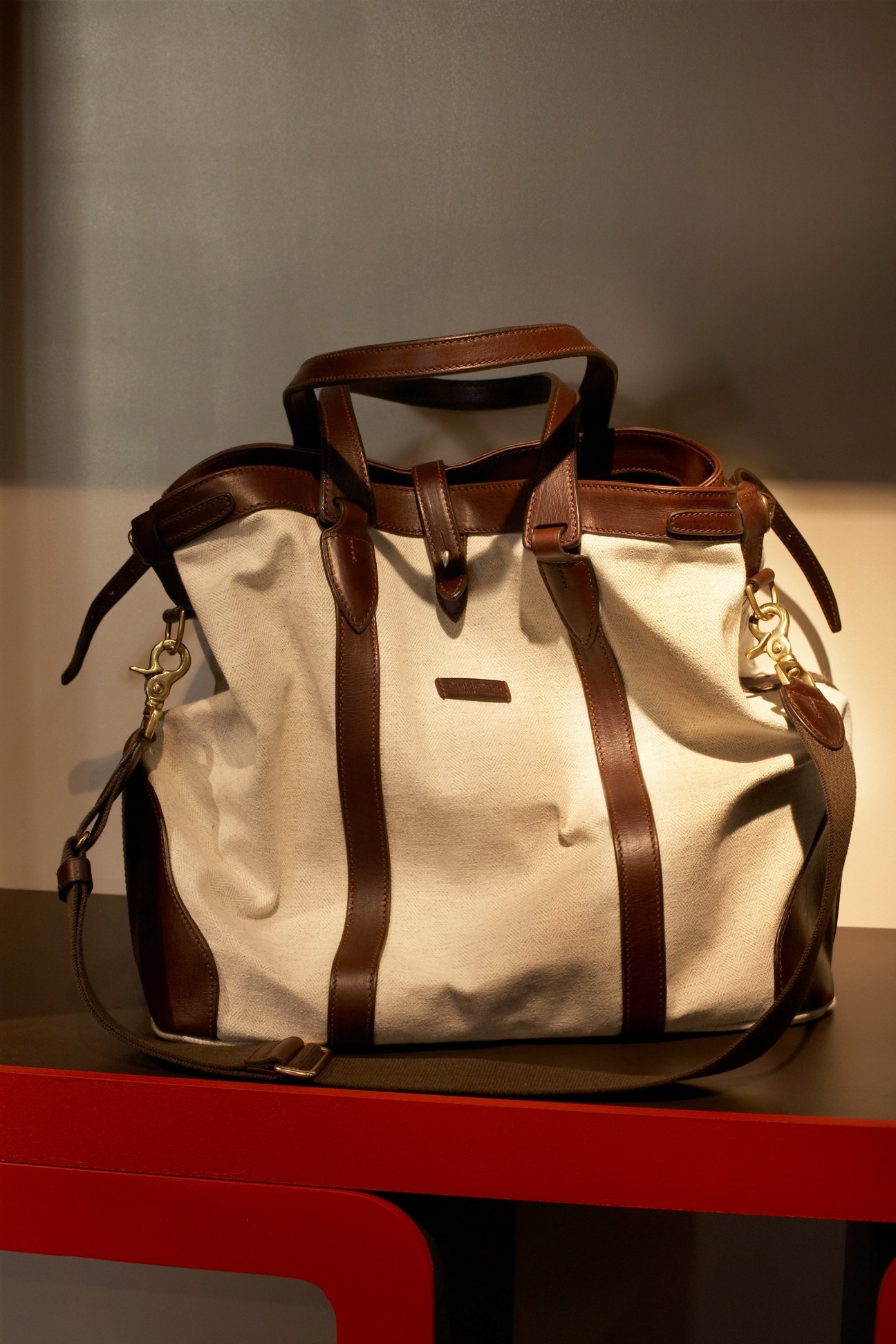 Cream canvas bag with tan leather handles and straps by Daniel & Bob.