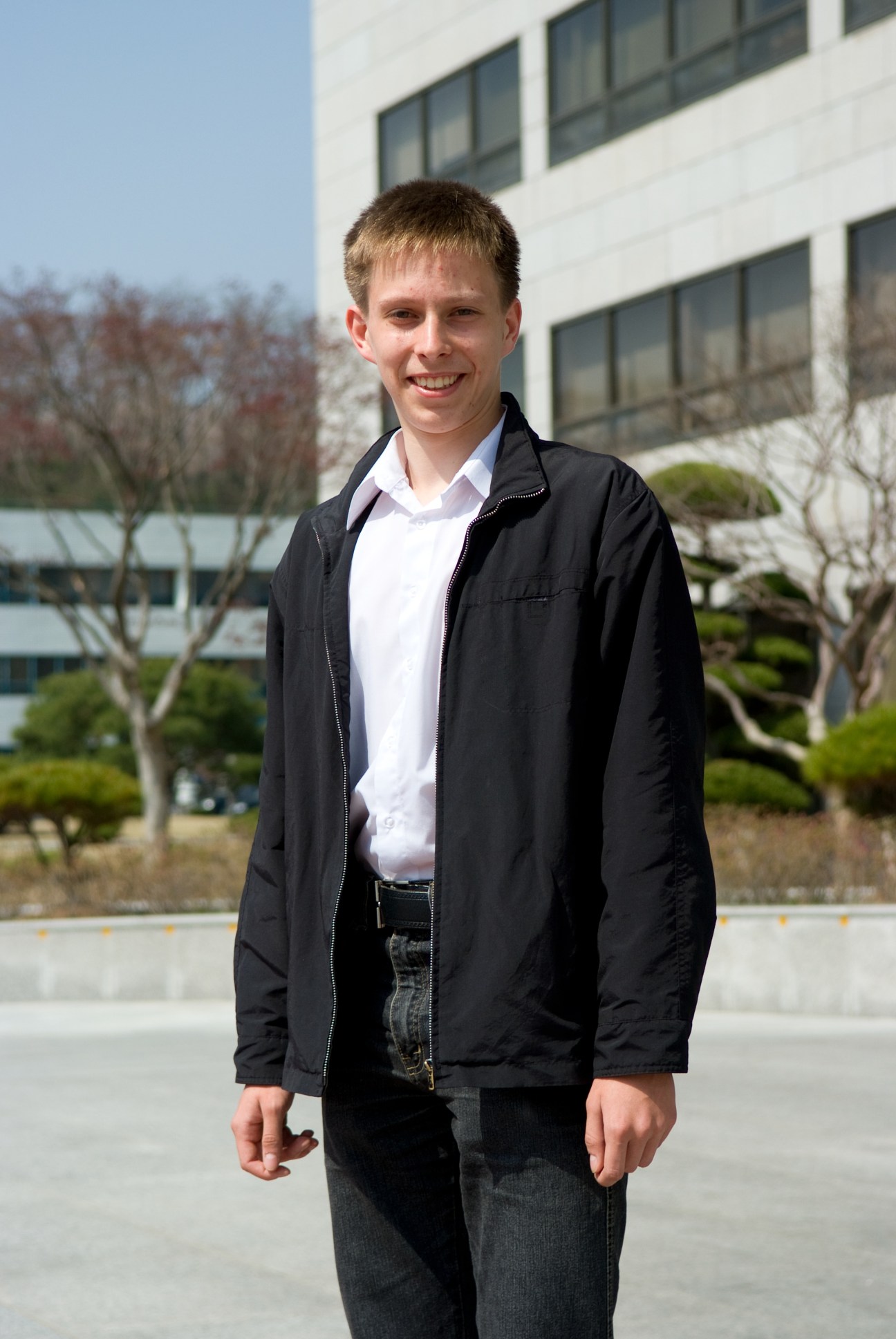 Andrei Shyshkalov, a Ukrainian computer science undergraduate at KAIST, stands outdoors on campus.