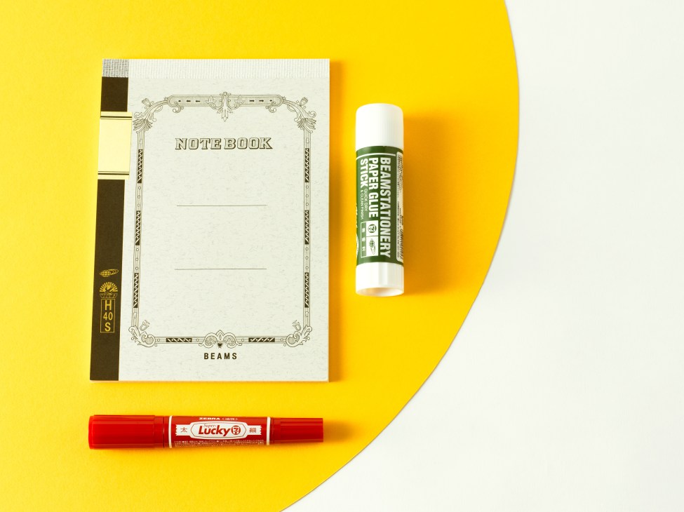 Beams notebook, Beams x 7-Eleven Mackee marker, and Lucky red marker on yellow background.