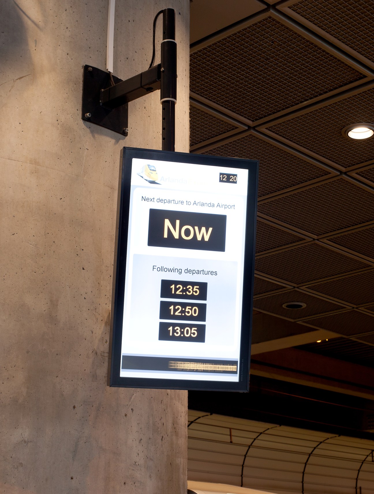 Digital display screen at Arlanda Express showing departure times to Stockholm airport.