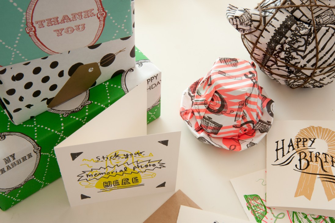 Colorful wrapping paper and gift cards with hand-drawn designs and text by Number 62.