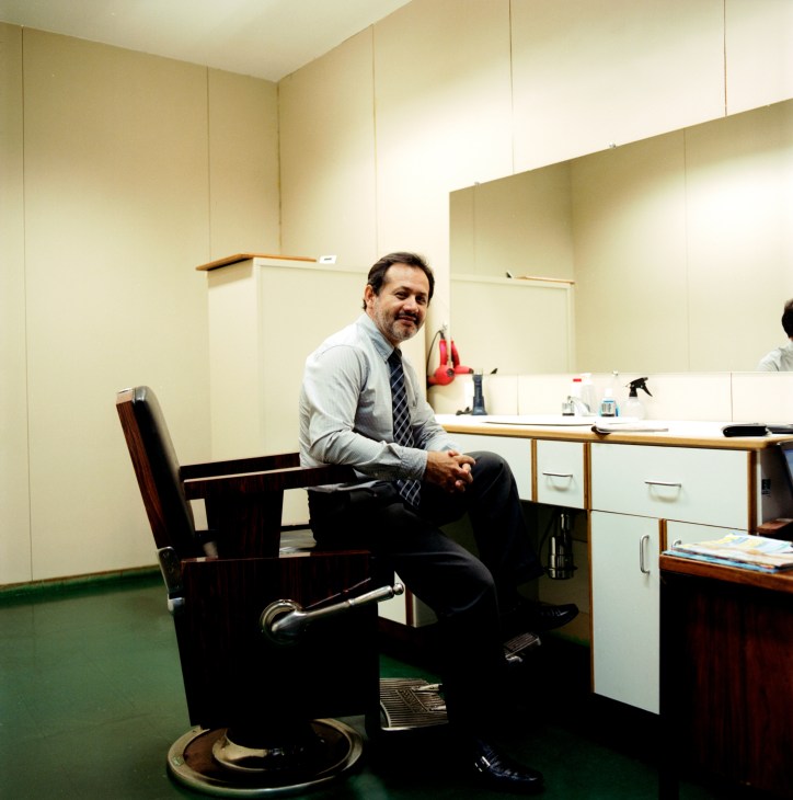 Roberto Moreira, the ministry's in-house barber, sits in his barber chair at the Itamaraty Palace in Brasília.