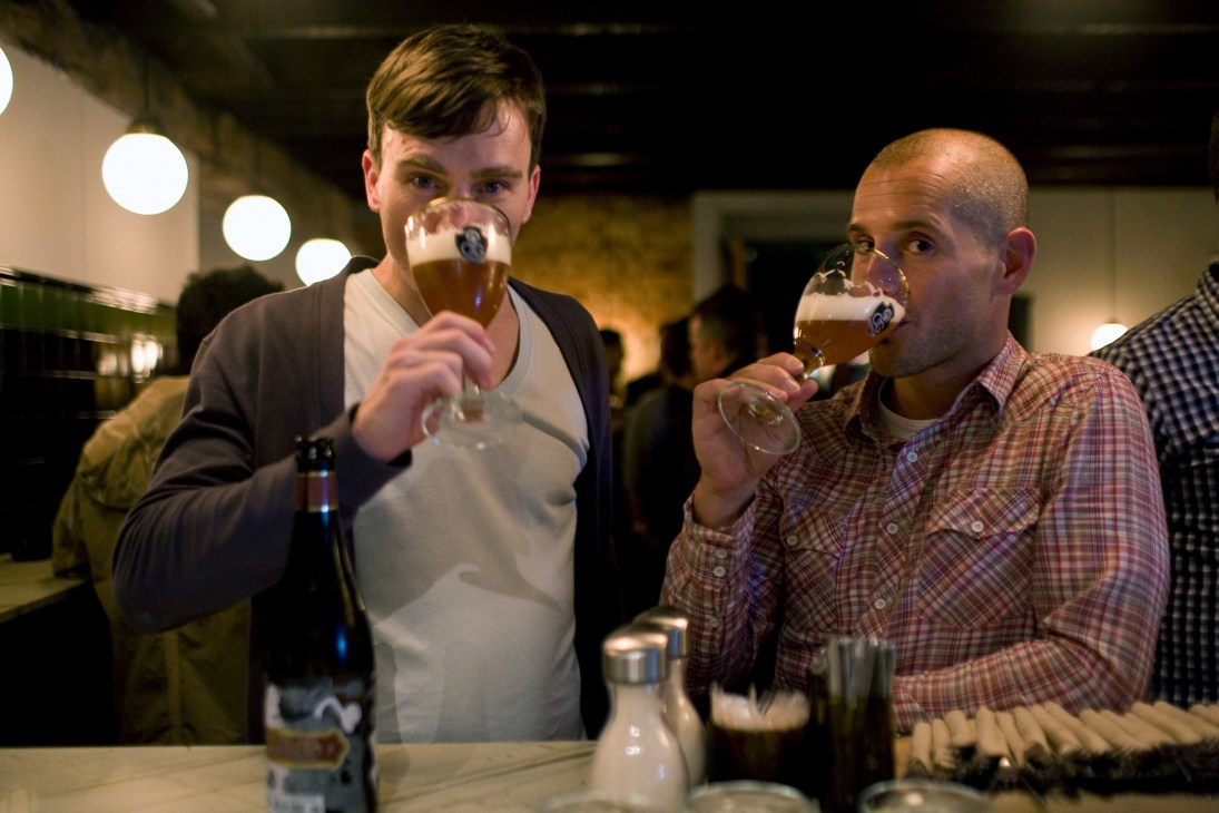 Two men drinking craft beer at Brewers & Union bar on Bree Street, Cape Town.