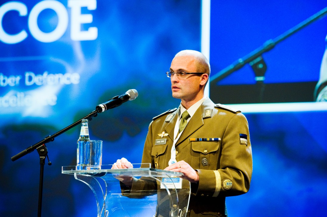 Col Ilmar Tamm in military uniform speaking at a podium during the CCDCOE cyber conflict conference.
