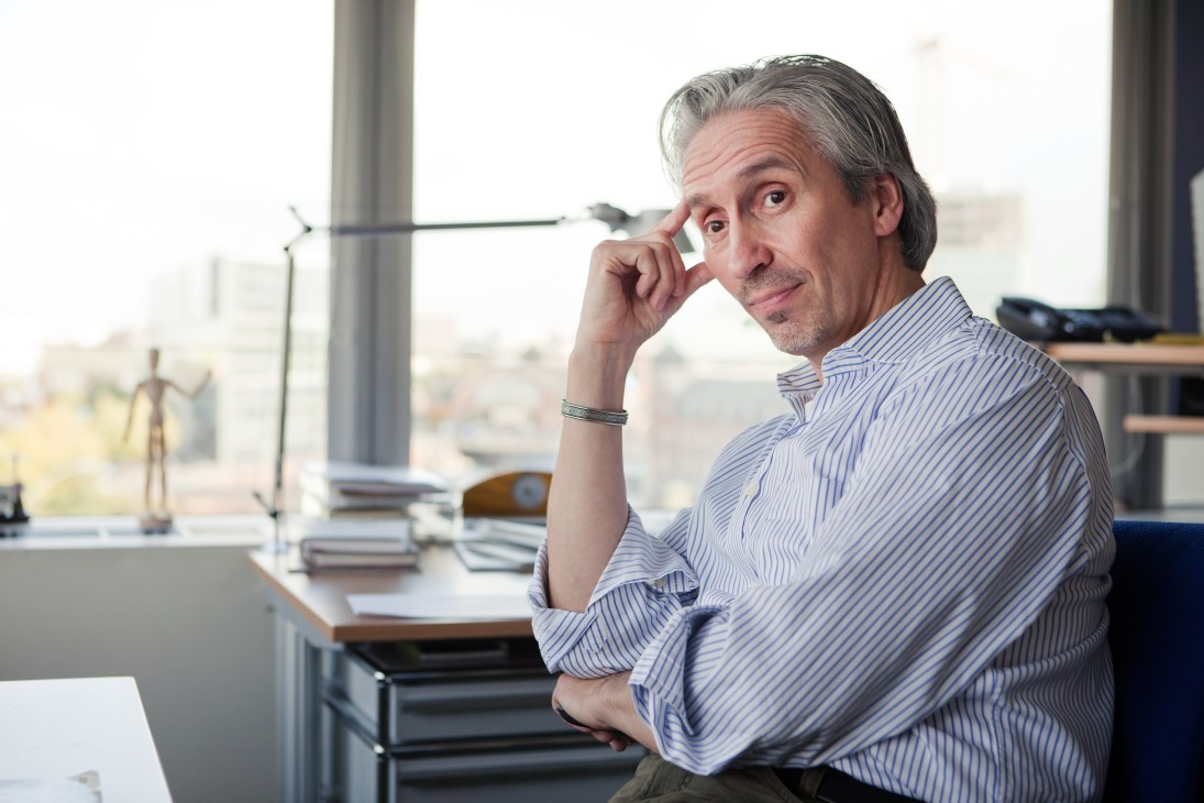 Stefan Kiefer, Der Spiegel's art director, sits at his desk in a corner office with city views.