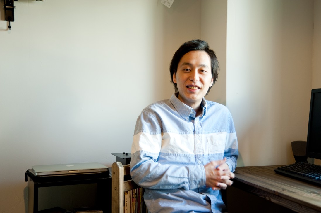 Yuichi Hagiwara, a web producer, sits at a desk in The Share shared living space in Tokyo.