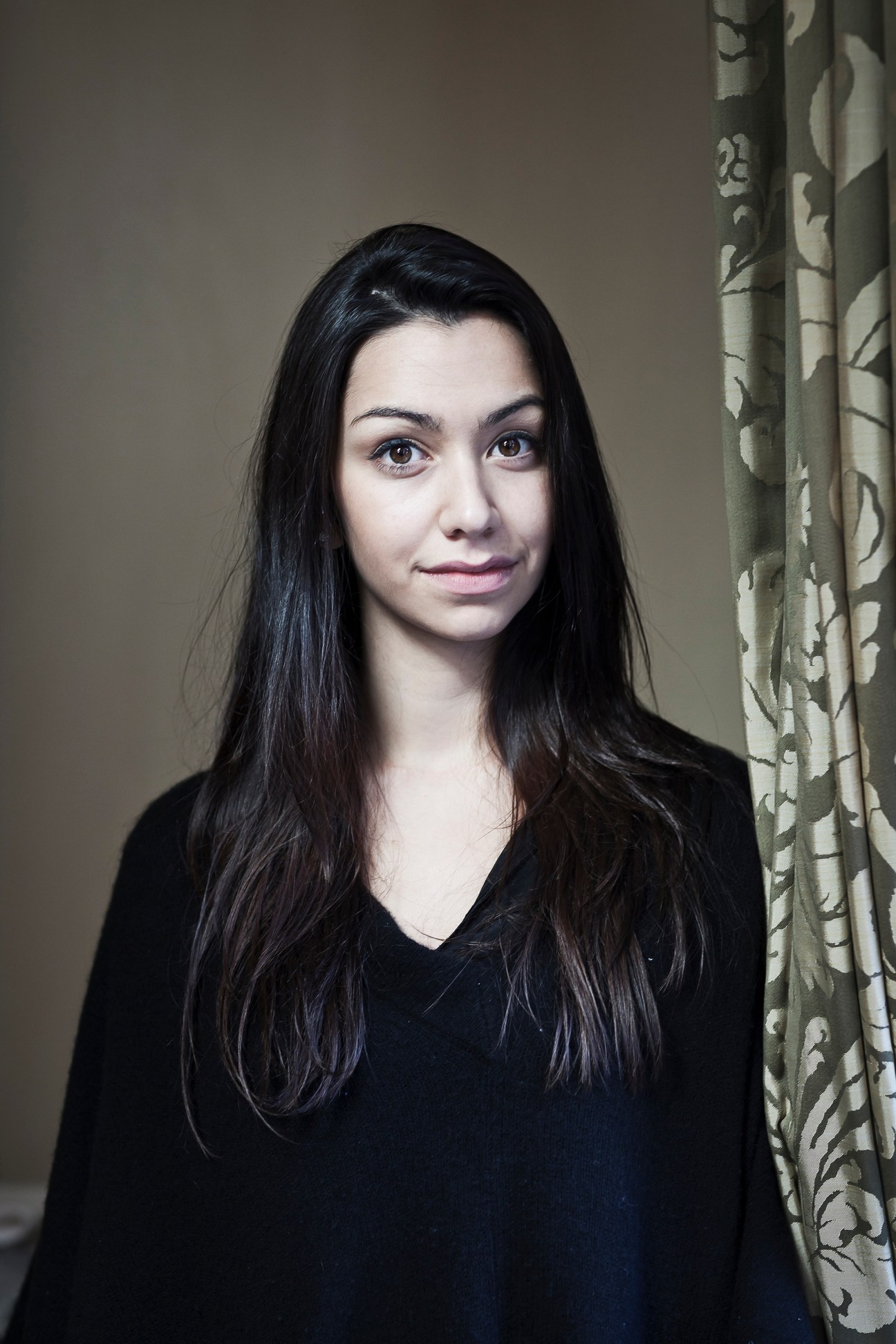 Portrait of Danielle Ryan, founding member of the Lir Academy of Dramatic Art, against a neutral background with patterned curtains.