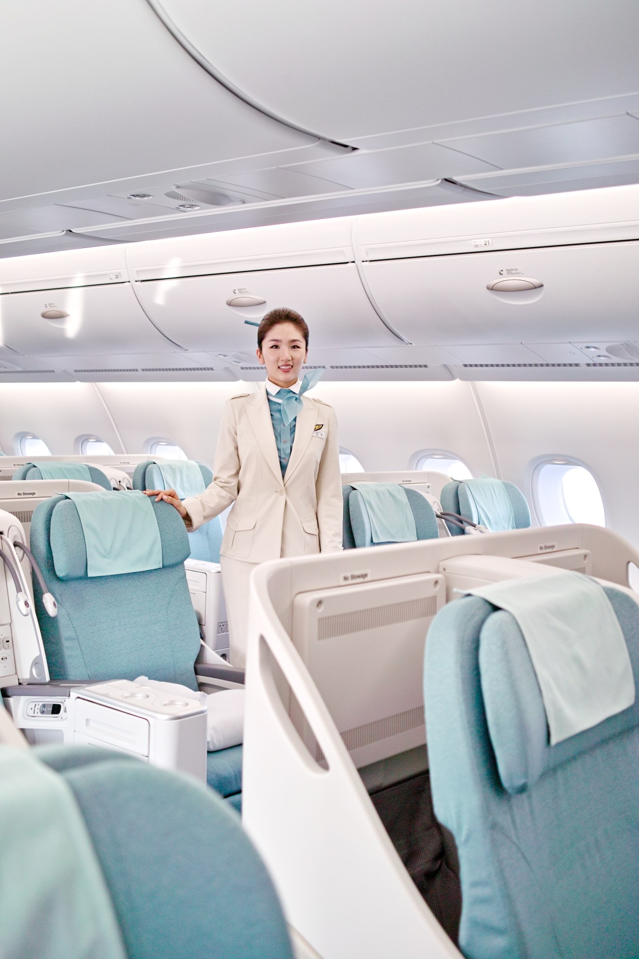 Korean Air flight attendant stands in the business class cabin of an A380 aircraft.