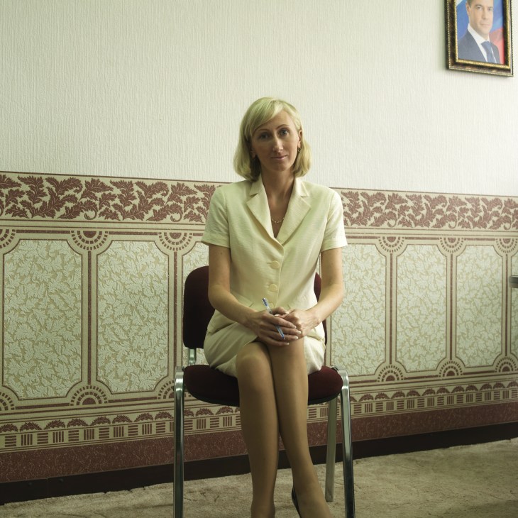 Oksana Gerasimova, Kamchatka's investment minister, sits in a Soviet-era office with ornate wallpaper.