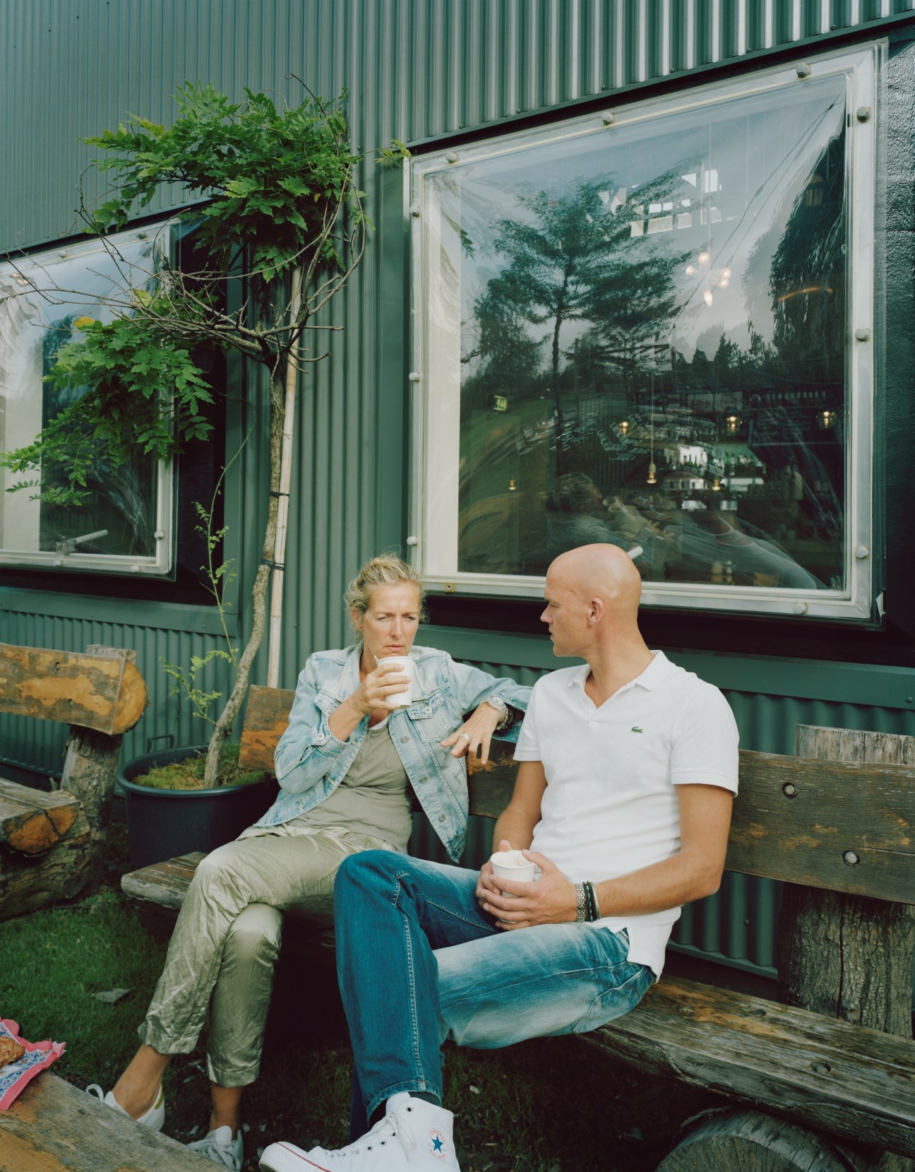 Two media workers having a coffee break outside the media park café.