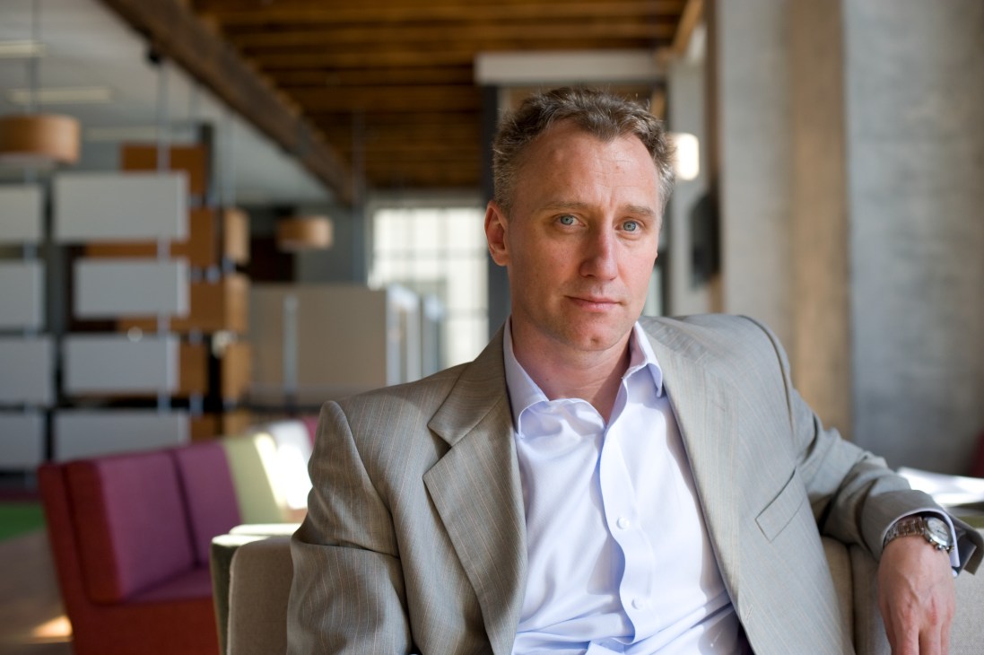 Mark Weldon, chief executive of the New Zealand stock exchange, sits in a modern office with wooden beams and colorful furnishings.