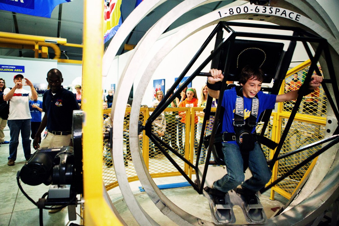 Children in blue flight suits train in a centrifuge simulator at Space Camp in Huntsville.