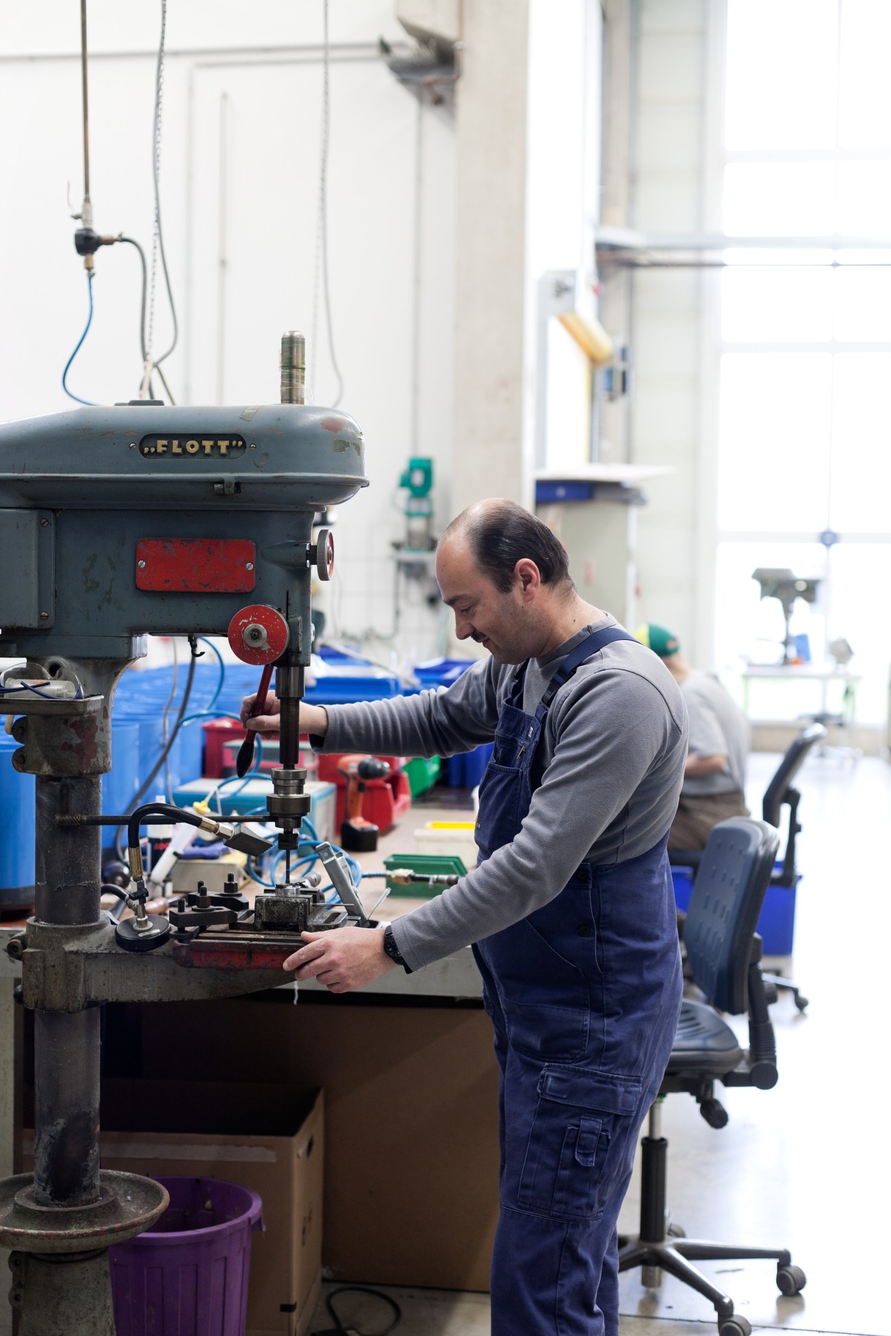 Worker operating machinery at Spülboy factory in Wuppertal, Germany.