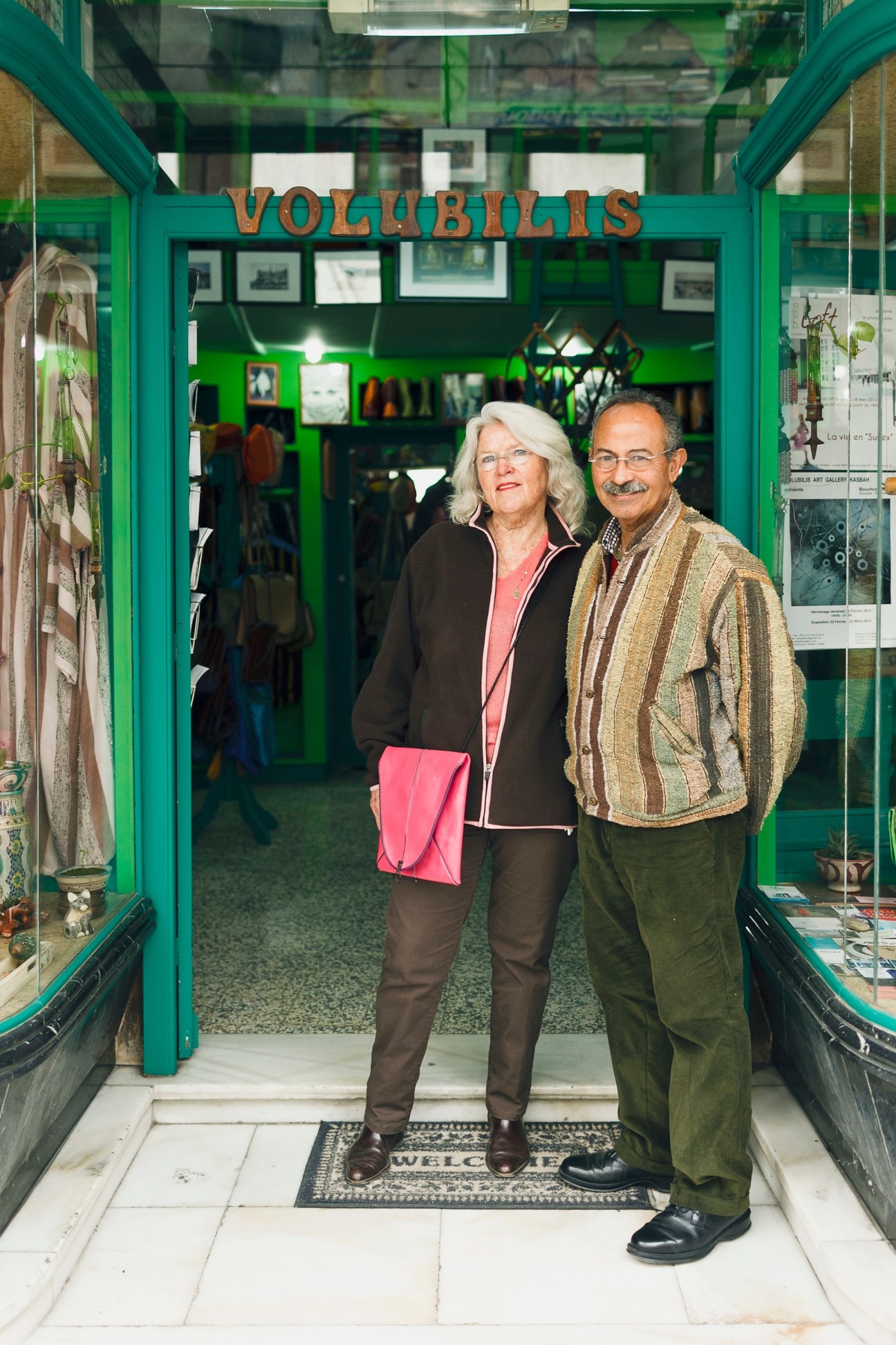 Karla and Mohammed El Fenni standing in the doorway of their Volubilis boutique with bright green frame.