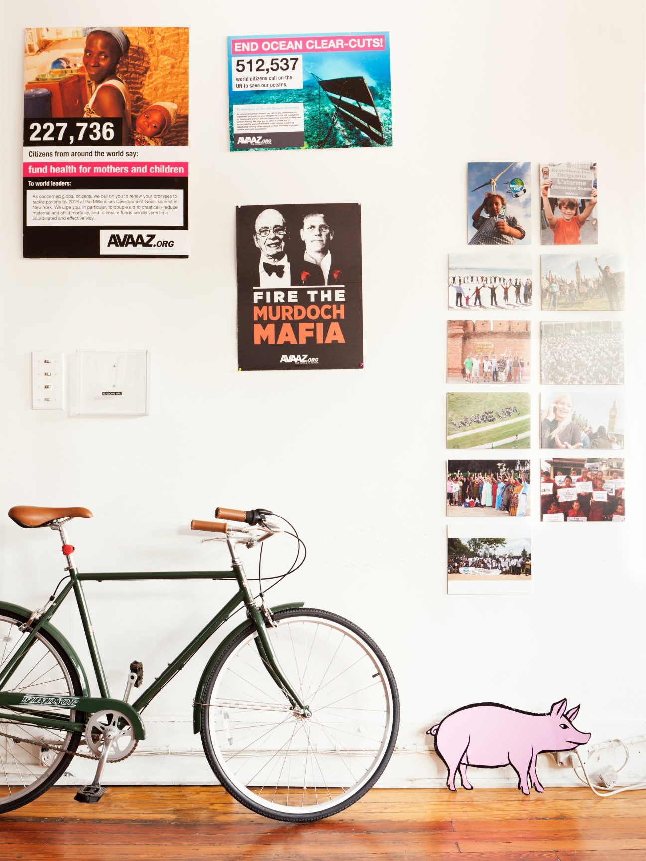 Ricken Patel, founder of Avaaz, stands in an office displaying campaign posters and activism materials.