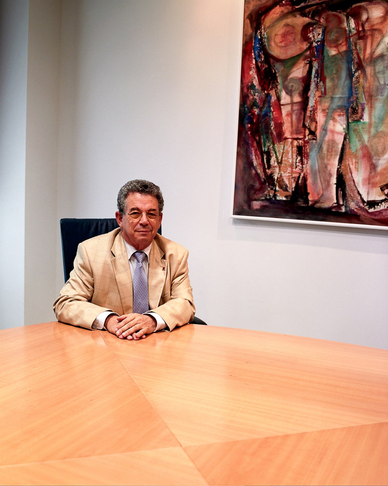 Freek van Beetz, adviser to Antillean prime minister, sits at a wooden conference table in an office.