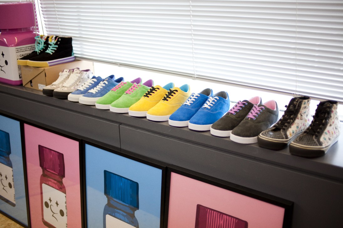 Colorful sneaker samples arranged on a windowsill display shelf.