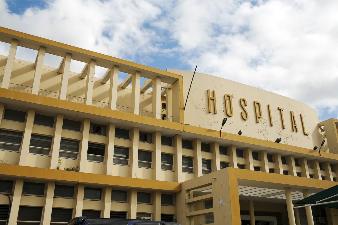 Maputo's Central Hospital, a large modernist yellow building with horizontal rows of windows and structural columns.