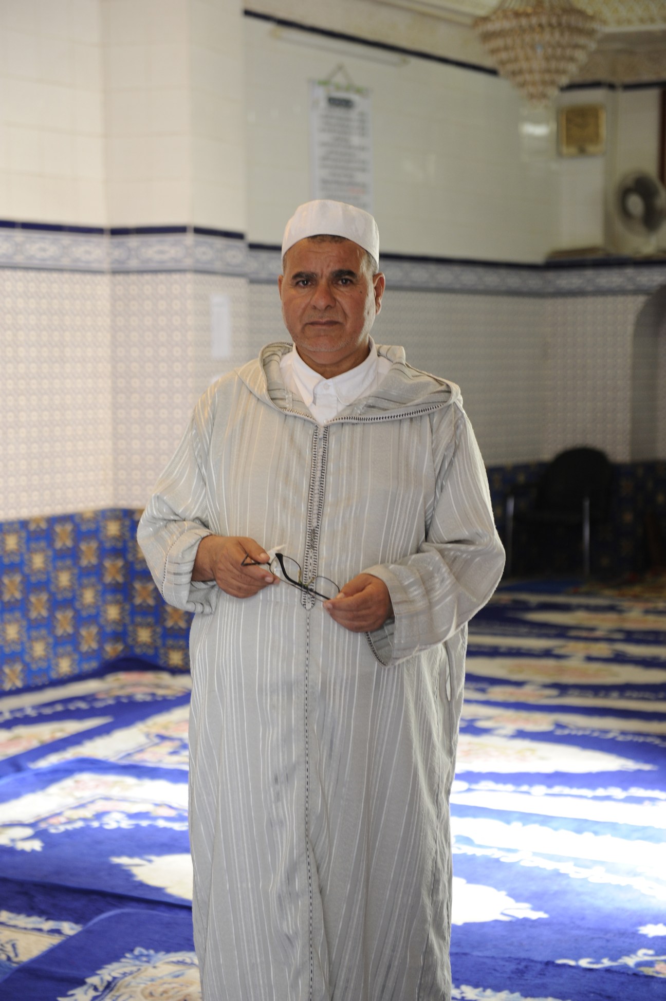 Imam at the Mantelete mosque in Melilla wearing traditional white clothing and cap