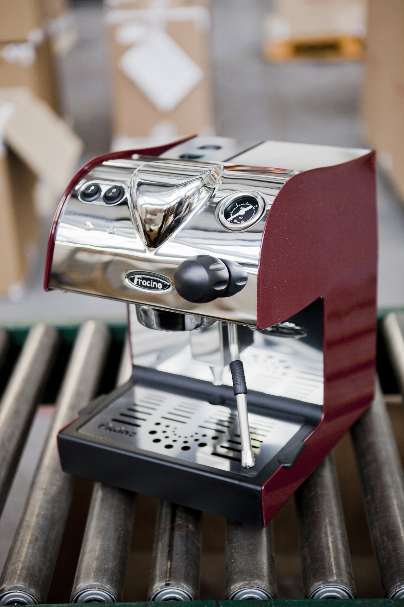 A red and stainless steel Fracino espresso machine on display.