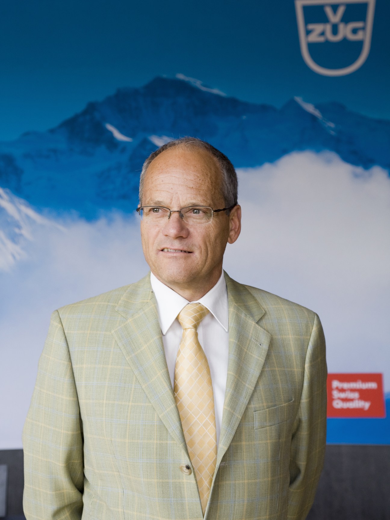 Export director René Fankhauser poses for a portrait in front of a V-Zug branded backdrop.