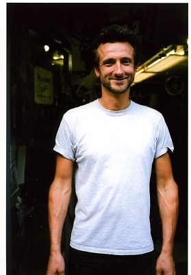 Trevor Lacey, manager of Bikefix bike repair shop, wearing a light blue t-shirt.