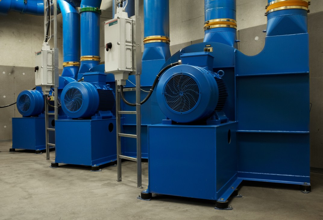 Blue industrial turbines and pipes at Envac's waste collection station in Hammarby, Stockholm.