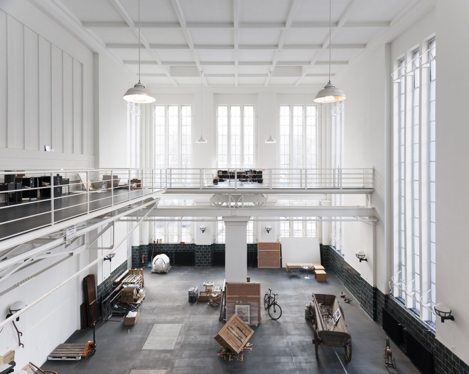 Interior of Elmgreen + Dragset's renovated Berlin pumphouse studio with high ceilings, mezzanine level, and industrial workspace.
