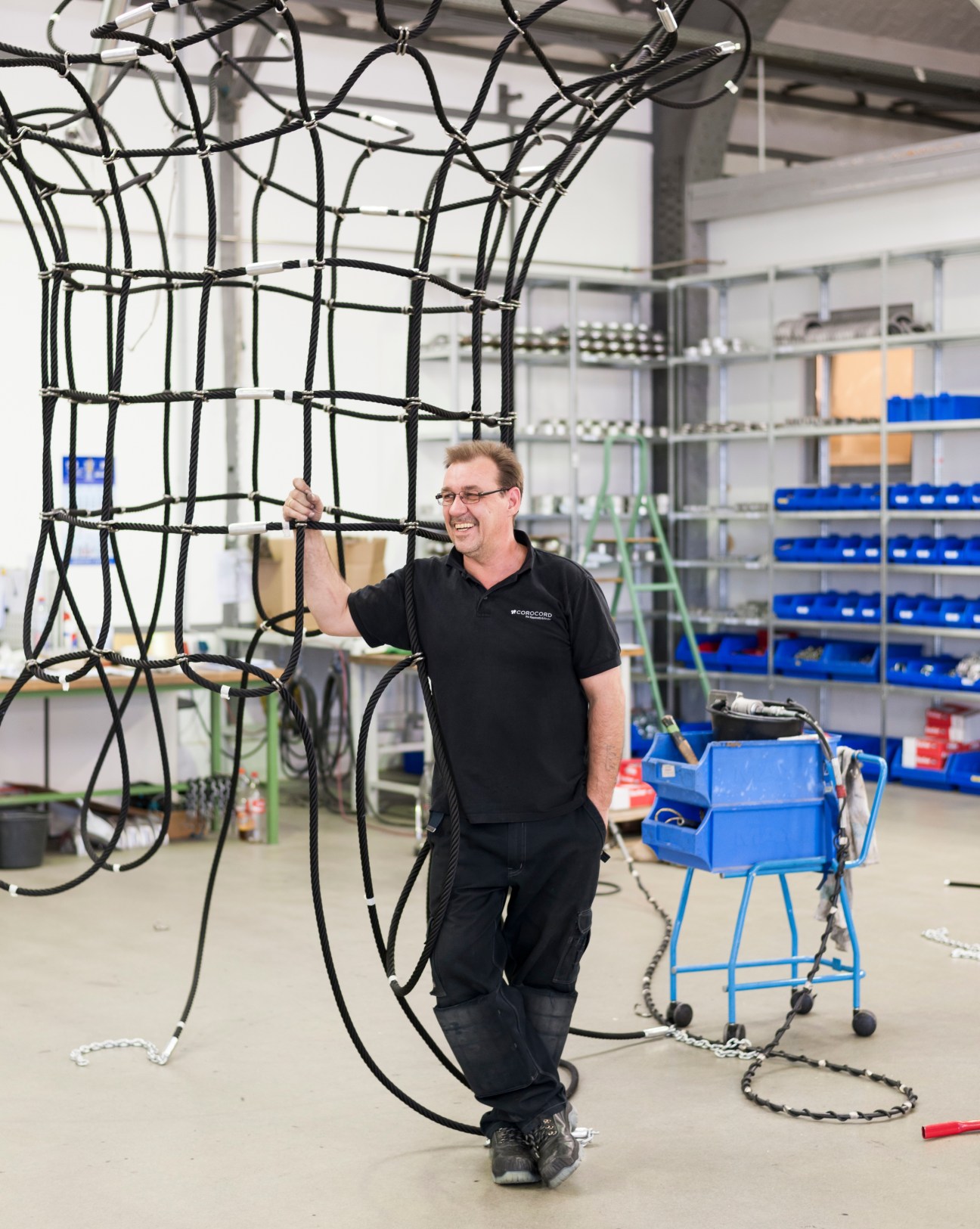 Klaus Lange, a Corocord assembly specialist, holding black synthetic rope in the Berlin factory.