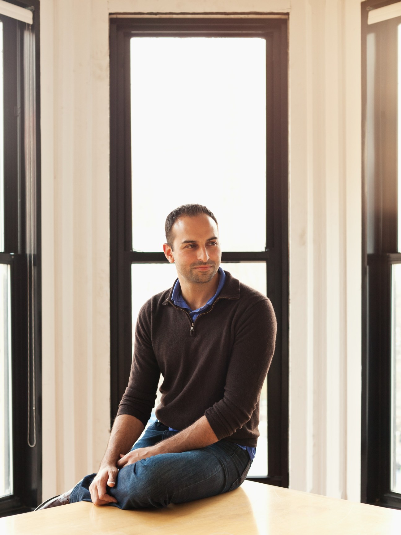 Ricken Patel, founder of Avaaz, sitting by a window in the organization's New York office.