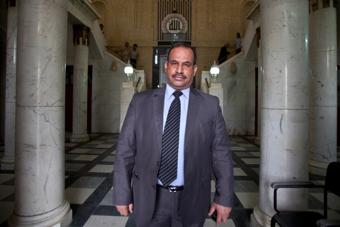 Omran Radhi, director general of the State Company for Iraqi Ports, stands in a marble-columned hallway.