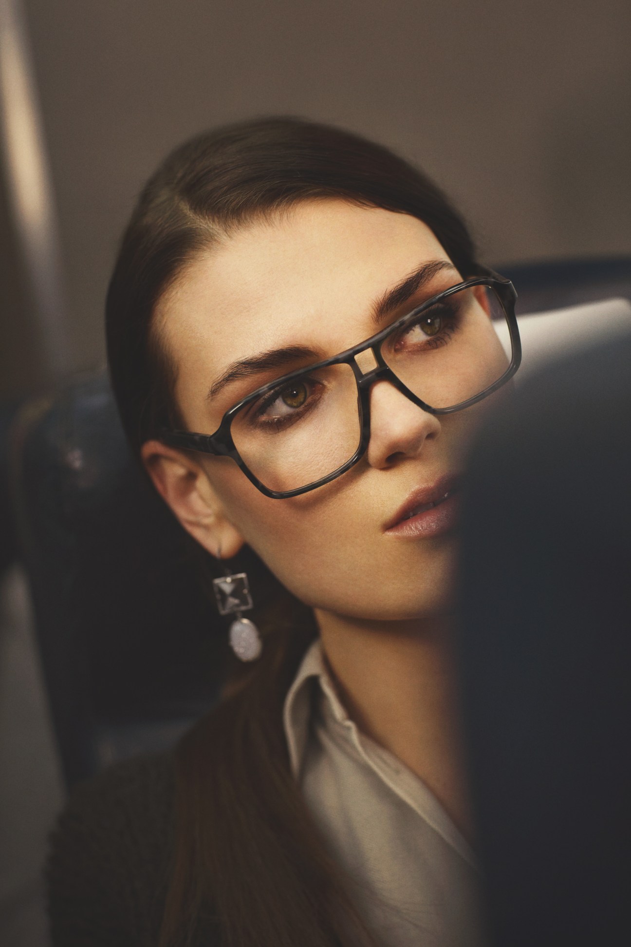 Model wearing Chanel glasses, Bottega Veneta earrings, Des Prés cardigan and Trussardi shirt.