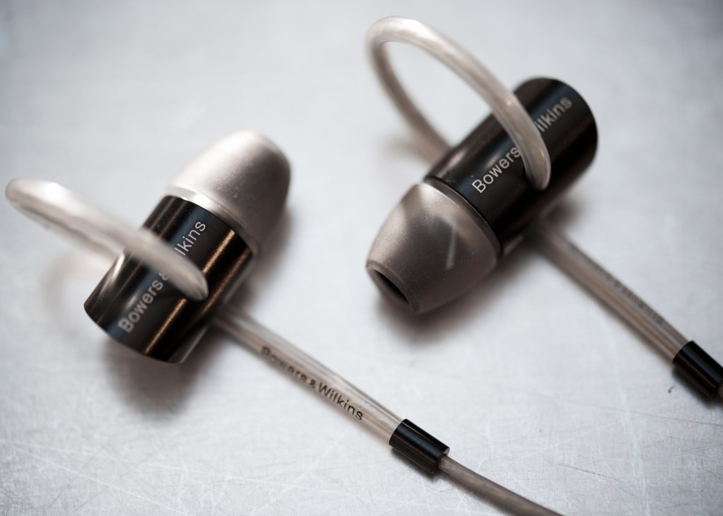 Bowers and Wilkins earphones designed by Native with black earbuds and white ear loops.