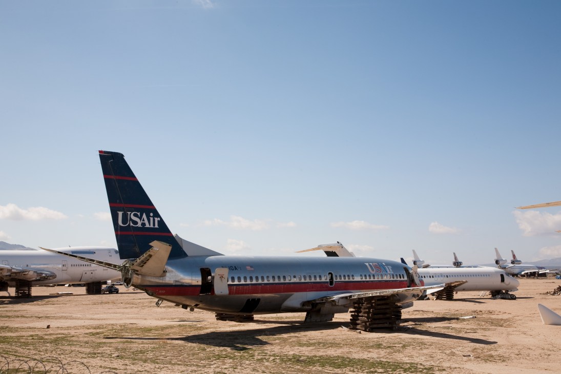 Retired USAir airliner in a desert boneyard awaiting dismantling.