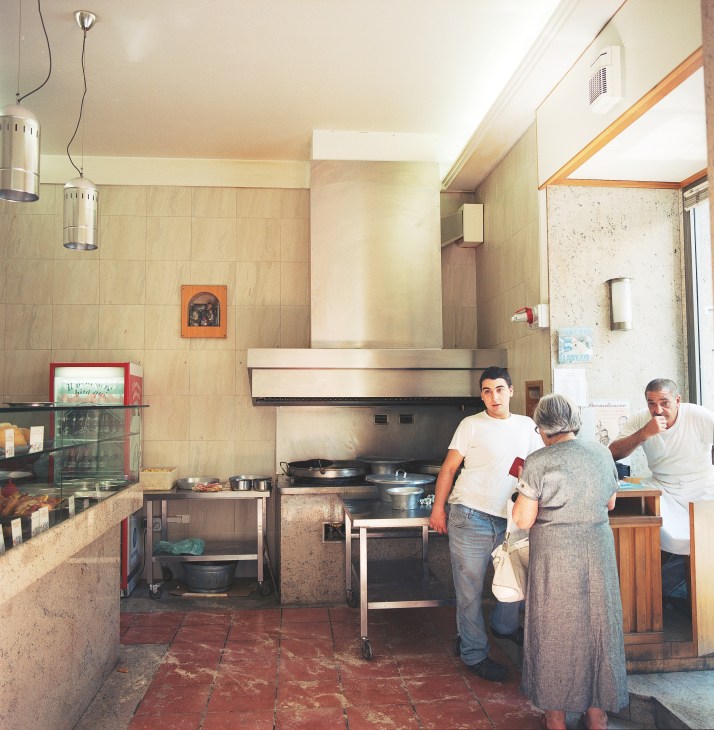 Interior of Friggitoria Vomero with staff and customer in traditional kitchen