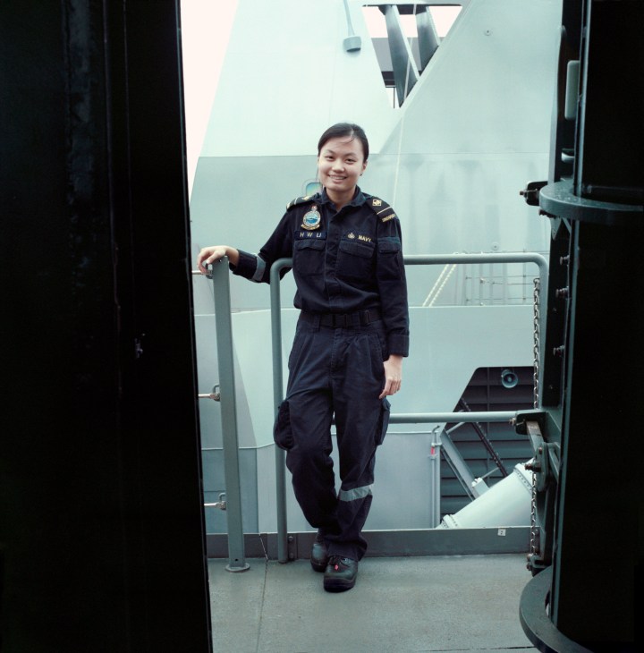 Li Huiwen, 26, a helmsman in the Republic of Singapore Navy, stands in naval uniform on the RSS Stalwart frigate.